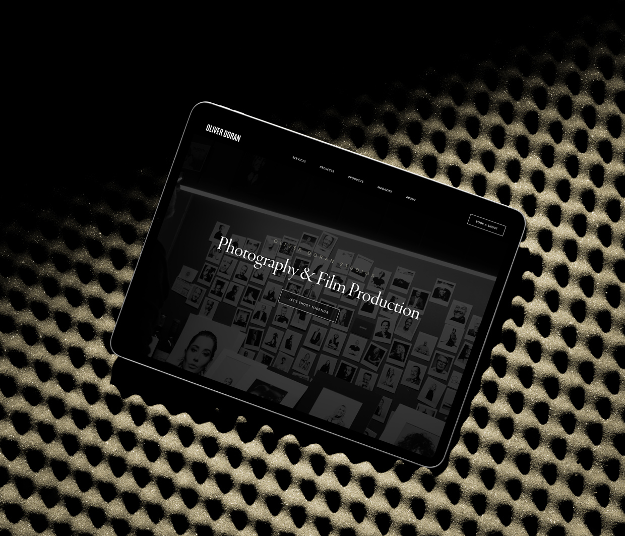 Tablet displaying photography and film production website.