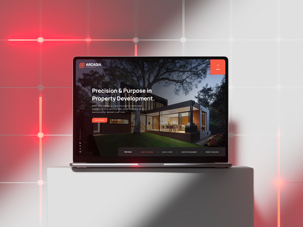 Arcadia website on laptop with modern house image